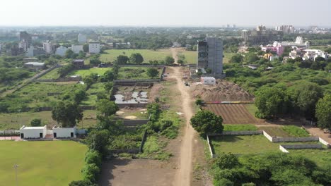 RAJKOT-CITY-AERIAL-VIEW-Drone-camera-moving-from-behind,-where-the-construction-work-of-a-high-rise-building-is-about-to-start