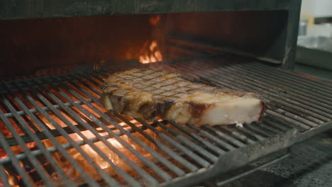 Flipping-dry-Australian-beef-steak-from-one-side-to-another-on-a-hot-fire-grill