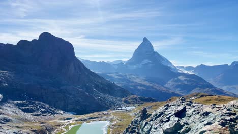 Mountain-Freedom:-Matterhorn-Mountain-Landscape-Near-Rotenboden-and-Gornergart,-Switzerland,-Europe,-Hiking-|-Swiss-Flying-Flag-High-Above-Mountainside