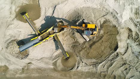 The-excavator-loads-screening-machine-in-construction-site