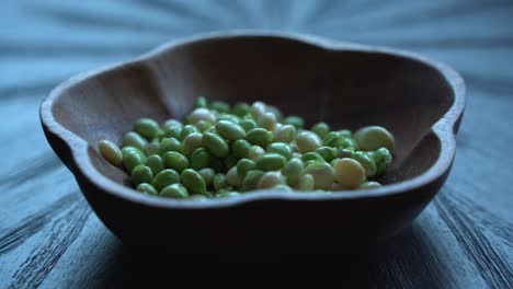 Pigeon-peas-in-bowl-taken-out-of-pod-on-table-after-being-picked-from-tree-healthy-green-fresh-protein-cultivation-harvested