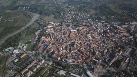 Aerial-hyperlapse-rotating-around-the-downtown-of-Alba,-Italy-during-the-Truffle-Fair