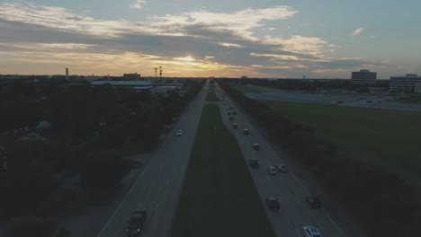 An-aerial-establishing-shot-of-NASA-Rd1-at-sunset,-with-thin-clouds-and-views-of-Johnson-Space-Center-in-Clear-Lake,-Houston,-Texas