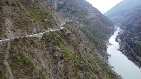 Cliffside-Road-Along-Indus-River,-Gilgit-Baltistan.-Aerial