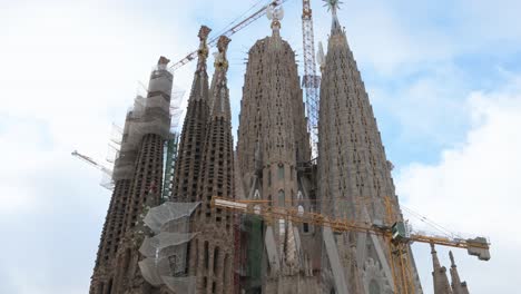 Tilt-down-view-of-the-Sagrada-Familia,-the-largest-unfinished-Catholic-church-in-the-world-and-part-of-a-UNESCO-World-Heritage-Site