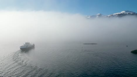 The-car-ferry-MF-"Haram"-sails-into-thick-fog-between-Dryna-and-Brattvåg,-just-north-of-Ålesund,-Norway