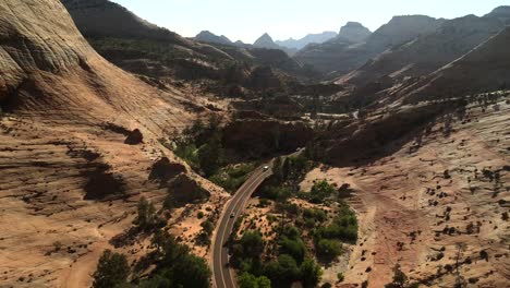 Aerial-cinematic-drone-shots-of-Zion-National-Park,-featuring-vehicles-traveling-on-the-road