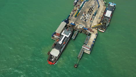 Seatrannathon-ship-towed-at-nathon-town-pier-on-koh-samui,-Thailand,-aerial-view