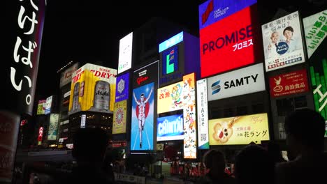 People-looking-at-the-billboards-in-Dotonbori-at-night-time-at-the-Chua-Ward-square
