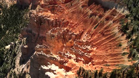 Comprehensive-cinematic-drone-footage-features-slow-motion-and-close-up-shots-that-provide-intricate-details-of-a-red-rock-formation-and-its-surrounding-landscape