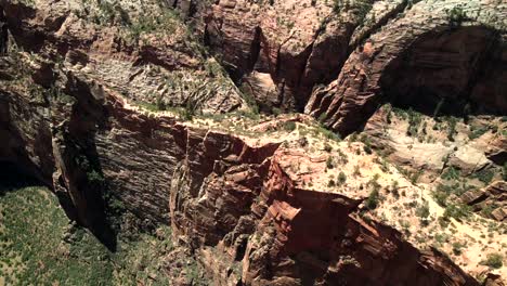 A-drone,-aerial,-and-cinematic-footage-of-Zion-National-Park-rock-formation-with-a-horizon-in-the-distance
