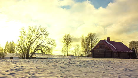 Wooden-log-cabin-in-the-woods-of-snow-covered-Riga,-Latvia-Time-lapse-sunset