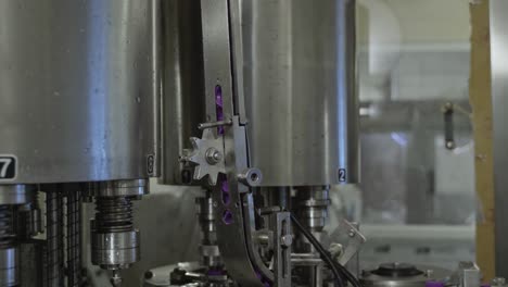 Unbeschriftete-Plastikflaschenverschlüsse-Bewegen-Sich-Auf-Dem-Fördersystem-Mithilfe-Fortschrittlicher-Automatisierter-Robotermaschinen-In-Einer-Trinkwasserfabrik
