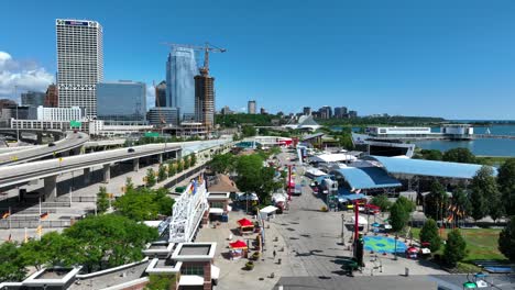 Summerfest-Park-in-Milwaukee,-WI,-with-festival-stalls,-urban-skyline,-and-Lake-Michigan-backdrop