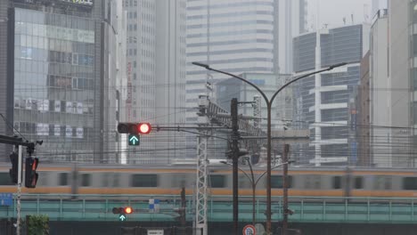 Shinjuku-Crossing-Traffic,-Train-Commute-and-Office-Buildings,-Tokyo,-Japan