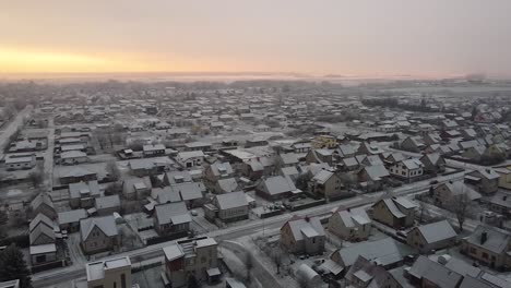 Aerial-view-of-the-picturesque-town-in-Europe-covered-in-snow-in-winter-at-sunrise,-Lithuania-in-winter