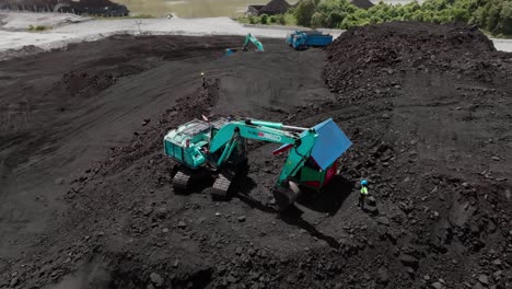 Excavator-And-Female-Quarry-Engineer-At-Work-At-Coal-Mining-Site