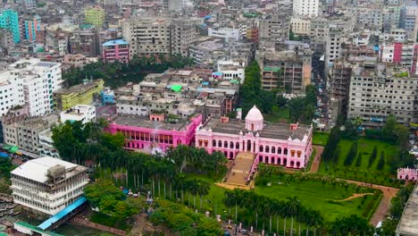 Aerial-view-of-Ahsan-Manzil-former-residential-palace-of-the-Nawab-of-Dhaka,-amidst-the-dense-urban-setting-of-Dhaka,-Bangladesh
