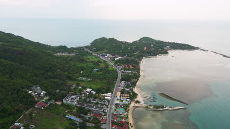 Tropical-lagoon-and-township-on-coastline-of-Thailand,-aerial-view