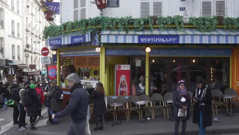 Static-shot-of-a-crepe-restaurant-exterior-with-people-queueing-to-order-food