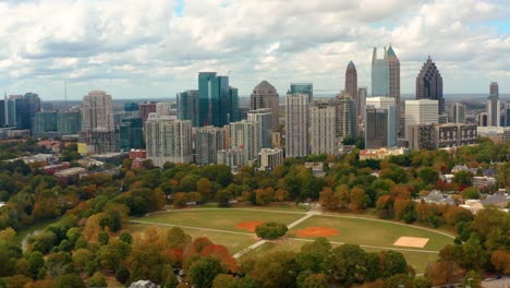 Flying-high-above-Piedmont-Park-and-downtown-Atlanta,-Georgia-in-the-Fall