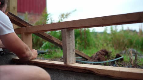 A-Man-is-Labeling-the-Wood-Intended-for-Constructing-a-Greenhouse-in-Indre-Fosen,-Norway---Close-Up