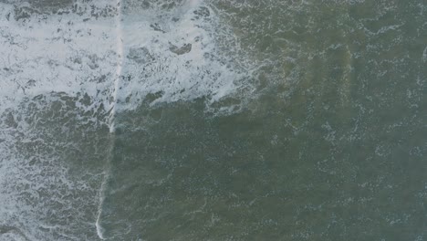 Aerial-Top-Down-Drone-shot-of-High-Tide-Shorebreak-at-Pismo-Beach-California-at-Sunrise