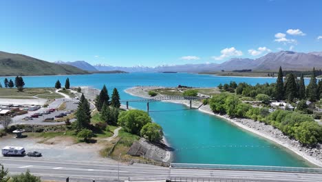 Amazing-aerial-of-tourist-attraction-and-historic-landmark-on-lakeshore-Lake-Tekapo,-New-Zealand