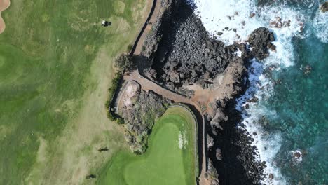 Golf-cart-drives-along-scenic-cliff-edge-of-Tenerife-at-Buena-vista-course