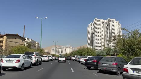 White-luxury-fancy-building-twin-tower-in-modern-city-of-Tehran-in-Iran-clean-street-safe-city-fresh-air-cars-parking-driving-today-Iran-travel-to-urban-life-traffic-and-pollution-city-landscape