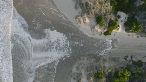 Aerial-Top-Down-Drone-shot-of-High-Tide-rivers-at-Pismo-Beach-California-at-Sunrise