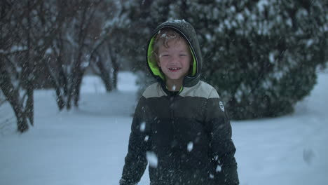 Happy-kid-on-Christmas-morning-playing-in-the-snow