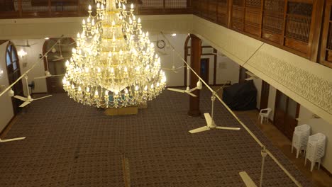 Overlooking-Prayer-Hall-With-Large-Illuminated-Hanging-Chandelier-At-Al-Masjid-Al-Burhani-In-Karachi