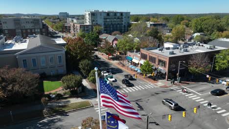 America,-North-Carolina,-and-UNC-flags-waving-in-downtown-Chapel-Hill,-NC