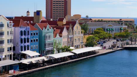 Drone-rises-to-reveal-colorful-facades-of-Handelskade-Punda-District-Willemstad-Curacao