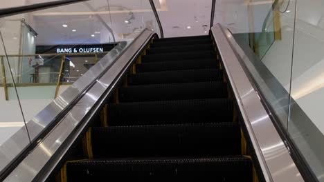 Escalator-going-up-a-floor-where-BANG-and-OLUFSEN-is-at-the-front-as-seen-in-a-mall-in-Bangkok,-easy-access-for-the-customers,-Thailand