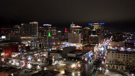 Salt-Lake-City-skyline-on-a-misty-nighttime-with-Christmas-lights-glowing---push-in-aerial