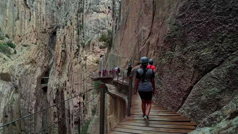 People-walking-along-the-Caminito-del-Rey-pathway,-Malaga,-Spain