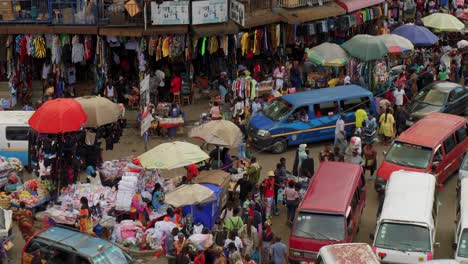 Crowded-packed-dirt-road-street-full-of-vendors-with-bright-colors-in-Adum-market