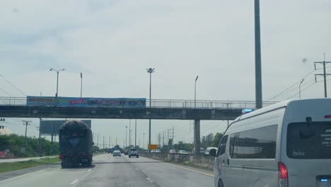 Ambulance-speeding-on-the-fast-lane-catching-up-with-time-as-it-responded-to-an-emergency-on-Mittraphap-Road,-Thailand