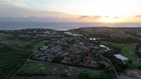 Caribbean-tropical-sun-set-behind-clouds-as-blue-hour-descends-on-golf-course-resort