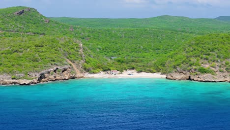 Aerial-establishing-view-of-Playa-Hunku-clear-Caribbean-ocean-waters,-Curacao