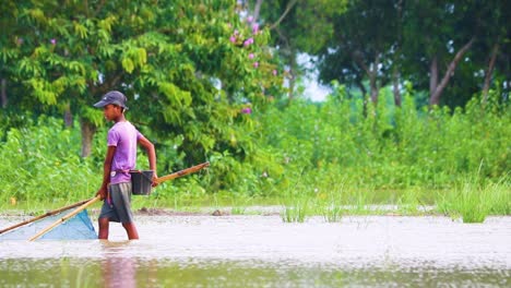 Rural-young-boy-traditional-fishing-net-in-wetland-Bangladesh-countryside