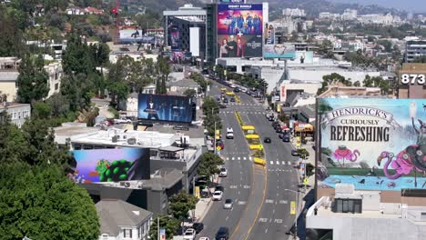 Traffic-on-Sunset-Boulevard,-Buildings-and-Billboards,-aerial-in-Los-Angeles