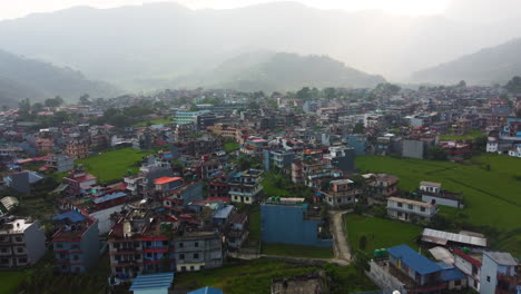 Tall-ramshackle-apartment-buildings-gathered-at-base-of-mountains-in-Pokhara-Nepal
