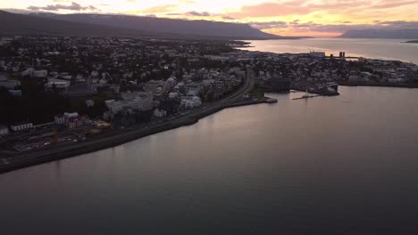 Aerial-reveal-of-Akureyri,-Iceland-at-sunset