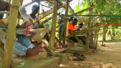 African-workers-from-local-community-manually-weaving-kente-traditional-fabrics