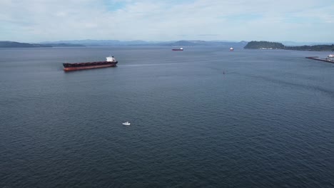 Aerial-of-Cargo-ships-on-the-Columbia-River-off-the-coast-of-Astoria,-Oregon
