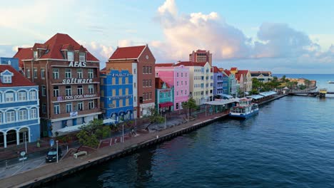 Drone-trucking-pan-left-to-right-along-colorful-buildings-of-Willemstad-Curacao
