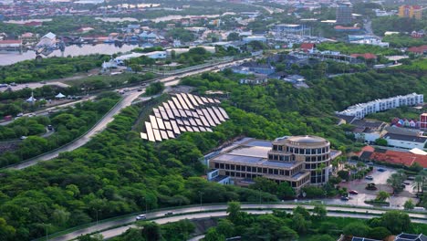 Solar-panels-above-Bank-of-Sint-Maarten-and-Curacao,-aerial-parallax-establishing